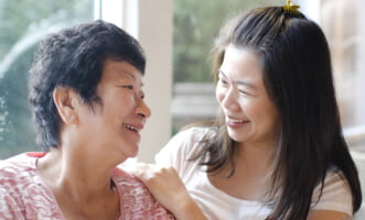 elder woman and caregiver smiling